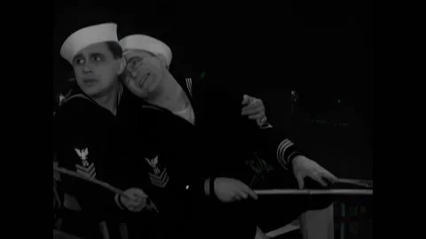 USA - 1930 - In this comedy, two sailors hold each other in a rowboat. They look Stock Footage 327743032