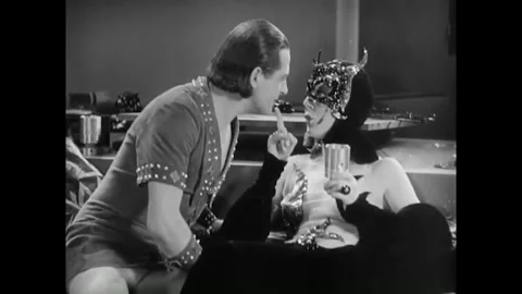 USA - 1930 - In this musical comedy, a man and woman in costumes speak on a Stock Footage 341990302