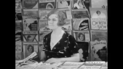 USA - 1930 - In this musical comedy, two men in suits fight at a music store. Stock Footage 325206028