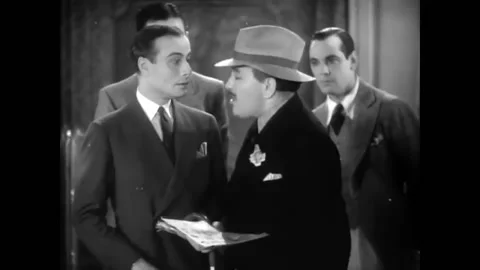 USA - 1930 - In this musical comedy, two men look at a newspaper clipping. A man Stock Footage 325215925