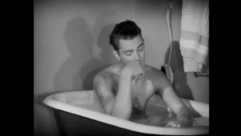 USA - 1930 - In this romantic comedy, a man shaving speaks with a man in a Stock Footage 341988803