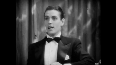 USA - 1930 - In this romantic comedy, a man and woman clap after dancing and a Stock Footage 341988942