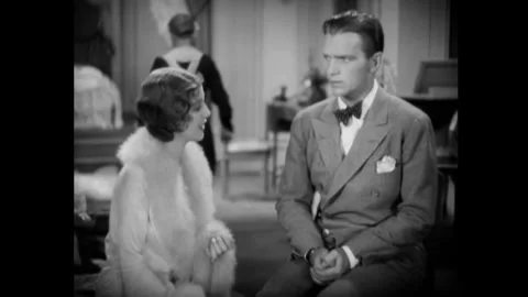 USA - 1930 - In this romantic comedy, a young man and woman speak in an elegant Stock Footage 341988848