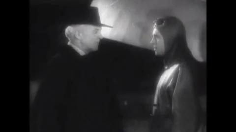 USA - 1930 - In this sci fi musical, a man speaks to two other men in front of a Stock Footage 341982733