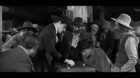 USA - 1930 - In this western, men gamble over a shell game. A steamboat rides in Stock Footage 323084053