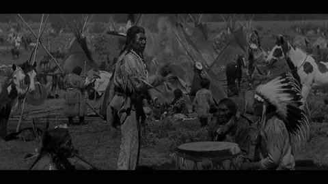USA - 1930 - In this western, a tribe of Native Americans play drums and sing. Stock Footage 323083351