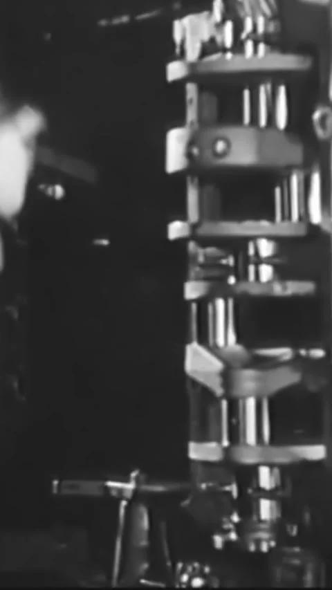 USA - 1930s - Factory workers put together car engines on an assembly line at a Stock Footage 339105859