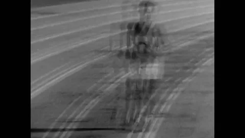 USA - 1931 - In this comedy, a drunk man runs in a relay seeing double. He drops Stock Footage 325204657