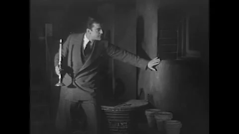 USA - 1931 - In this crime drama, a man looks out the window of a basement, Stock-Footage 341973953