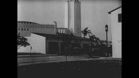 USA - 1932 - In this comedy, two cabs navigate a busy road with men on ladders Stock Footage 340573199