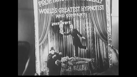 USA - 1932 - In this comedy, two men are shown a poster of themselves hypnotized Stock Footage 341980720