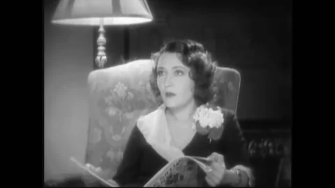 USA - 1932 - In this pre-code drama, a man opens a radio cabinet and starts Stock Footage 327740611