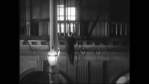 USA - 1932 - In this pre-code drama, a man jumps to a fire escape ladder from a Stock Footage 327745787