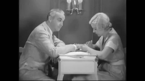 USA - 1932 - In this pre-code drama, a woman gives a man a manicure. He asks her Stock Footage 327746714