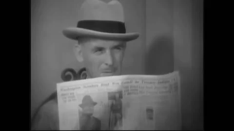 USA - 1932 - In this pre-code drama, a man peers down from behind a newspaper at Stock Footage 327747292