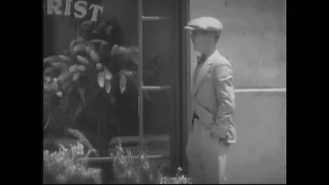 USA - 1932 - In this pre-code drama, a man enters a florist shop and speaks Stock Footage 327749086