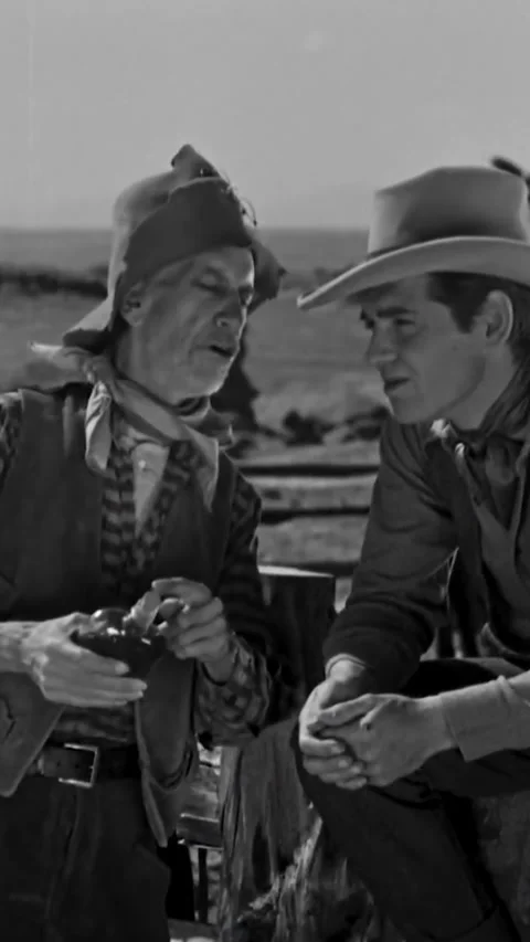 USA - 1934 - In this western, a drunk talks to a cowboy who is sitting on a Stock Footage 342928298
