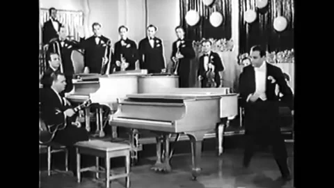 USA - 1935 - The orchestra commits mutiny, and the conductor sits at the piano. Video stock 327754904