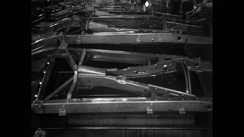USA - 1936 - Car frames come off an assembly line. They are spun around on Stock Footage 327736135