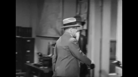 USA - 1937 - In this mystery, a grumpy editor enters a newsroom. A man does an Stock-Footage 341979055