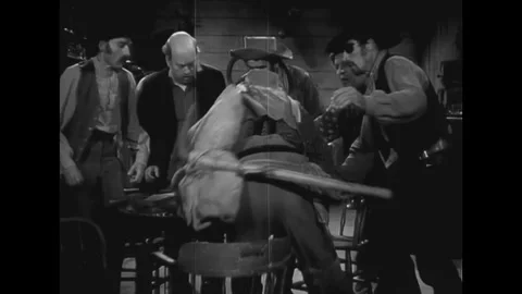 USA - 1937 - In this western, men pull open a sack of gold on a table in a Stock Footage 341989922