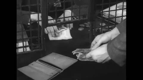 USA - 1938 - A bank teller exchanges German marks for a woman's American Stock Footage 254194265