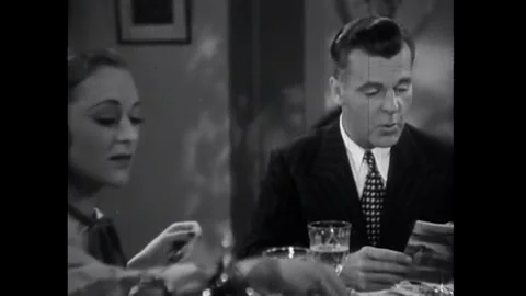 USA - 1938 - In this romantic comedy, a man speaks with a woman at a breakfast Stock Footage 341990845