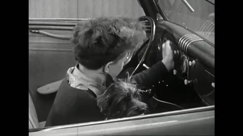 USA - 1940 - In this comedy, a boy sits in a car with a dog pushing buttons. A Stock-Footage 323223773