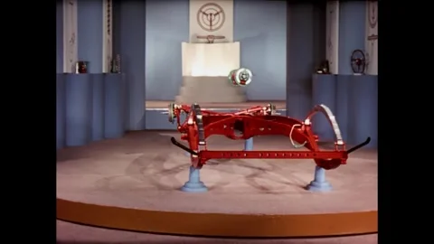 USA - 1940 - Stop-motion animation depicts tires and other car parts rolling by Stock Footage 341326868