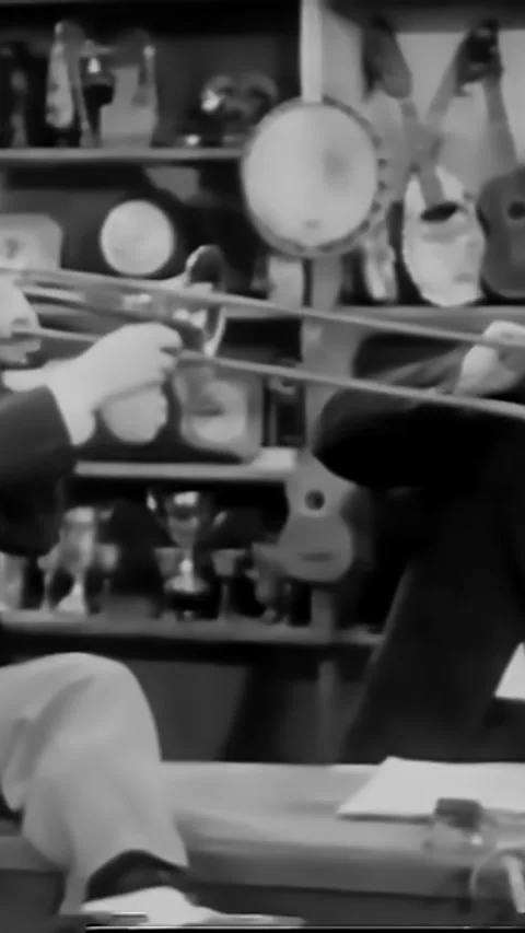 USA - 1944 - A tap dancing couple enters a bar where a trombonist and Stock Footage 342805789