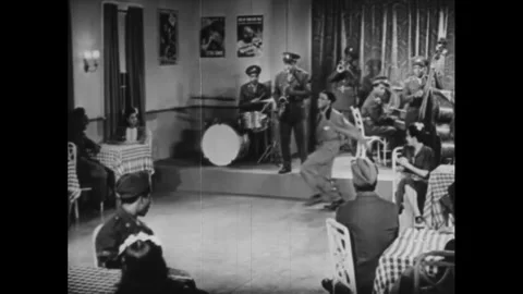 USA - 1944 - Two men start dancing as Louis Jordan's band plays a fast jazz Stock Footage 340650648