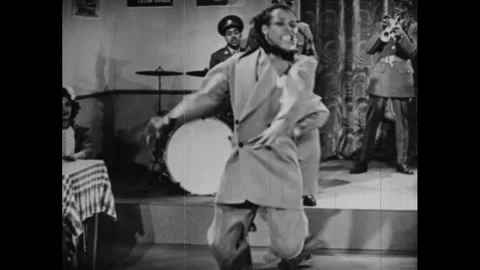 USA - 1944 - Two men wrap up a swing dance performance as Louis Jordan's band Stock Footage 340650673