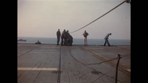USA - 1945 - Maintenance staff work with ropes and pipes to rescue a warplane Stock Footage 296690156