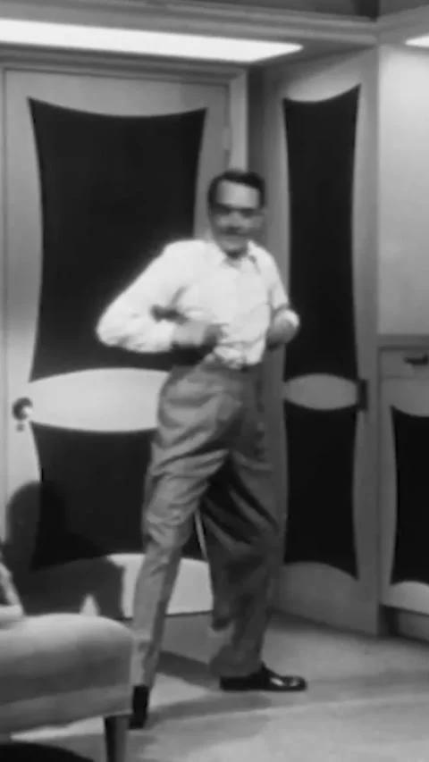 USA - 1947 - In this comedy, a man is putting on his suspenders and his tie Stock Footage 342644940