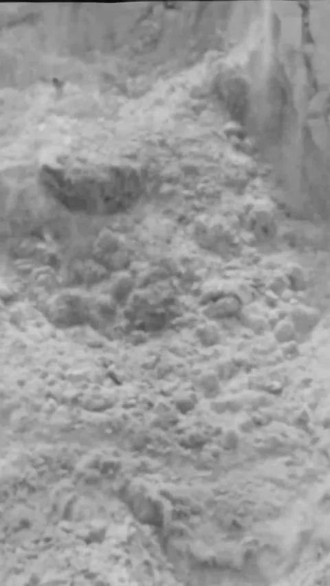 USA - 1948 - Explosives are used to loosen sand from a hillside, and it is mixed Stock Footage 340314023