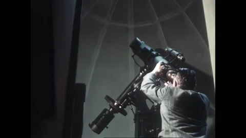 USA - 1948 - A girl uses a microscope and a man uses a telescope. Neons flash in Stock Footage 327745683