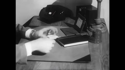 USA - 1948 - A man writes notes on pieces of paper. Amounts for furniture are Vídeo Stock 328192008