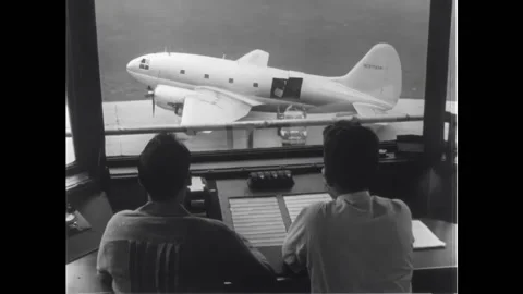 USA - 1949 - Air traffic controllers look at a plane from a tower. The plane Stock Footage 328190615