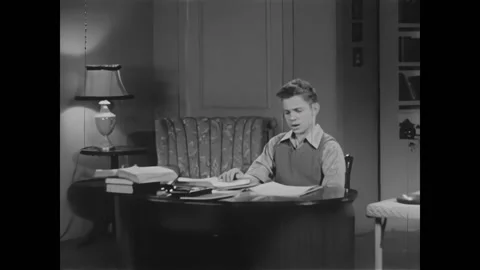 USA - 1949 - The boy looks at math notes on a desk about geometry. He reads Video stock 327741122