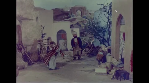 USA - 1950 - A man pulls a donkey through a village to an inn. Stock Footage 328192648