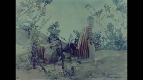 USA - 1950 - A merchant pulls a donkey through the wilderness. He eats at a Stock Footage 328184294