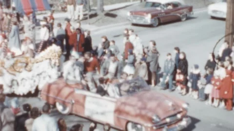USA - 1950s: 50s car pulls a boat shaped float during a parade Stock Footage 258215455