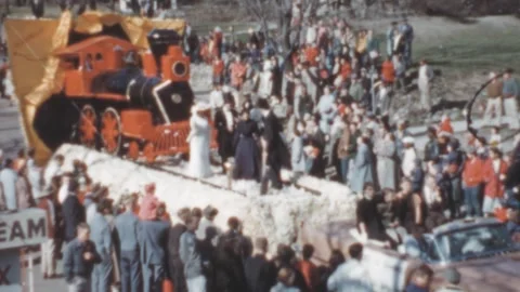 USA - 1950s: car pulls a float with a steam train during a parade Stock Footage 258215498