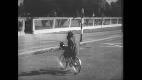 USA - 1950s - A chimp gives a left turn signal on a bicycle. He gets off the Stock Footage 327748610