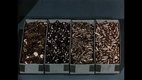 USA - 1950s - Close-up of nuts and bolts used at a manufacturing plant. Stock Footage 340660076