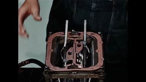 USA - 1950s - Close-up of a worker using a screwdriver and pliers on factory Stock Footage 340660046
