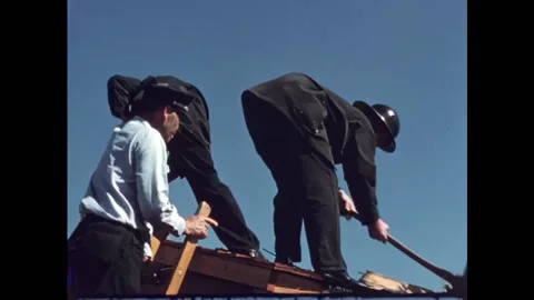 USA - 1950s - Fireman rip the roofing off of a structure after it was burned in Stock Footage 327737227