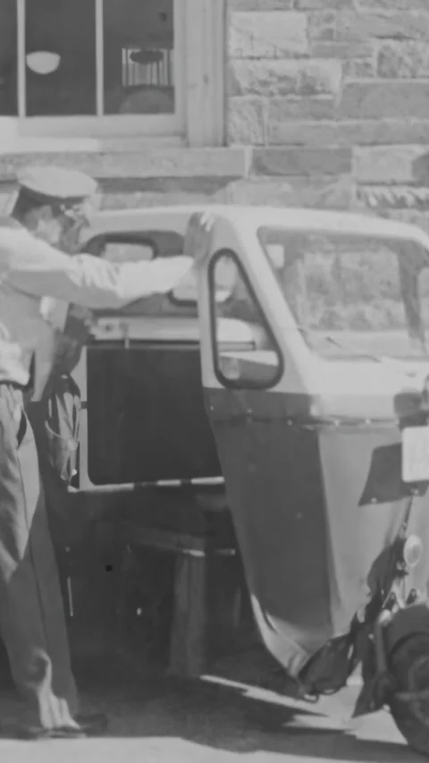 USA - 1950s - A mailster driver demonstrates how to manually start the engine. Stock Footage 340297002