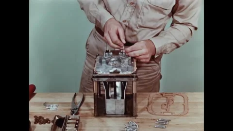USA - 1950s - A man assembles metal equipment by hand and with a power tool. Stock-Footage 340660194