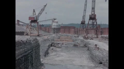 USA - 1950s - A man directs the use of mobile cranes at a reservoir's Stock Footage 340665791
